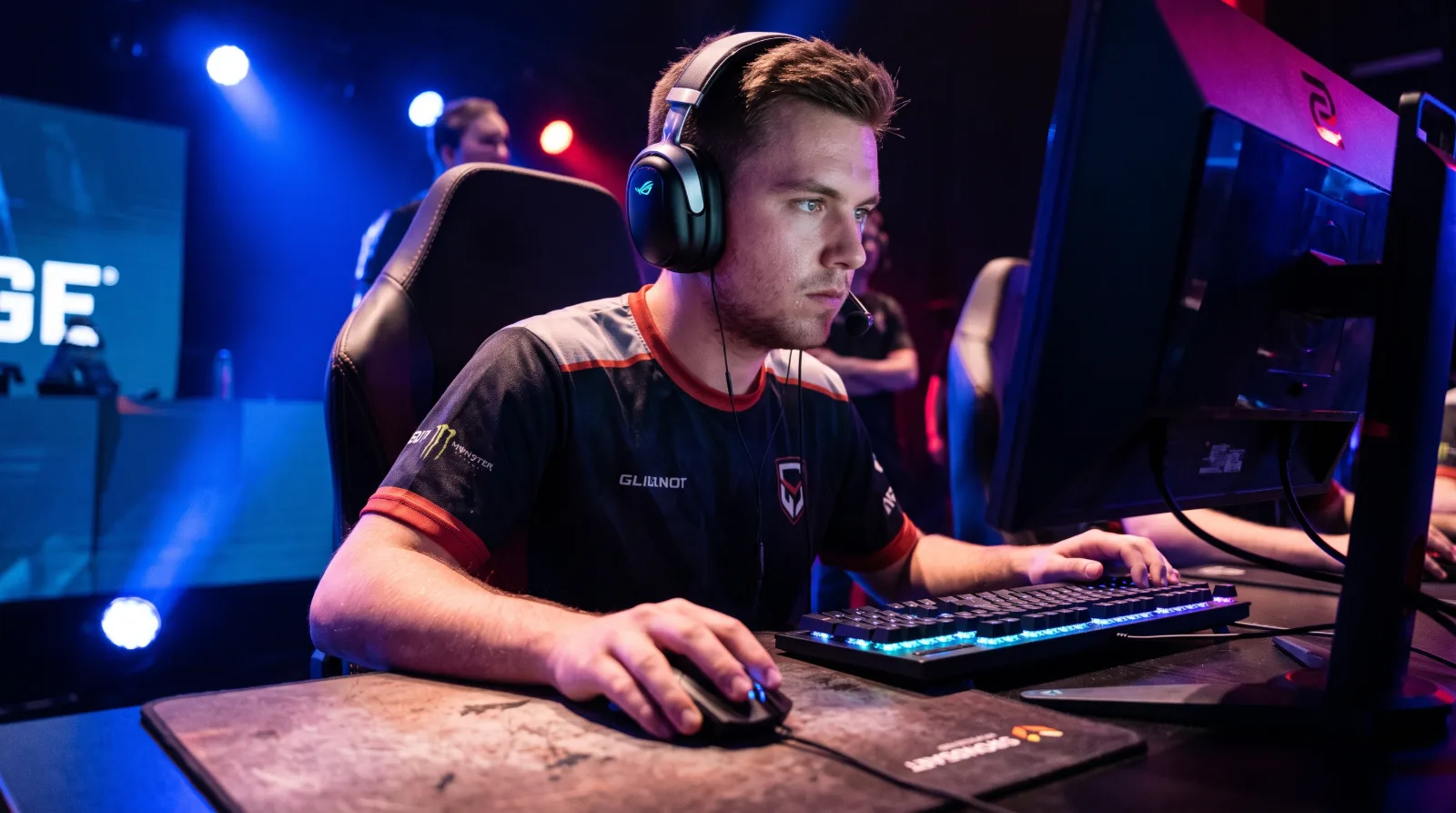 Professional Esports Player intensely focused on competitive match with backlit gaming gear