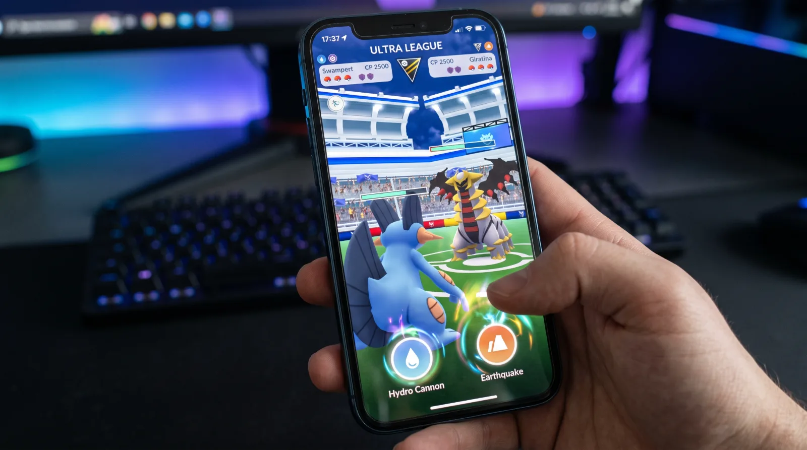 A realistic close-up photo of a mobile phone screen displaying an intense Ultra League battle arena with Swampert and Giratina